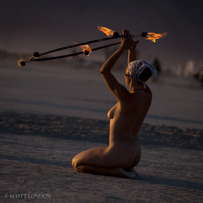Nude hooper at sunrise at Burning Man 2013 (Photo by Scott London)