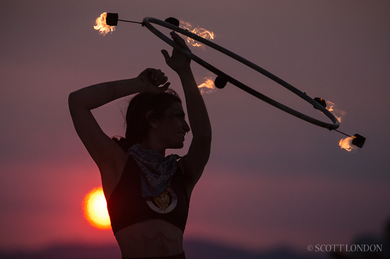 Surka, a fire-dancer from Portland, puts on a show at sunrise at Burning Man 2013 (Photo by Scott London)