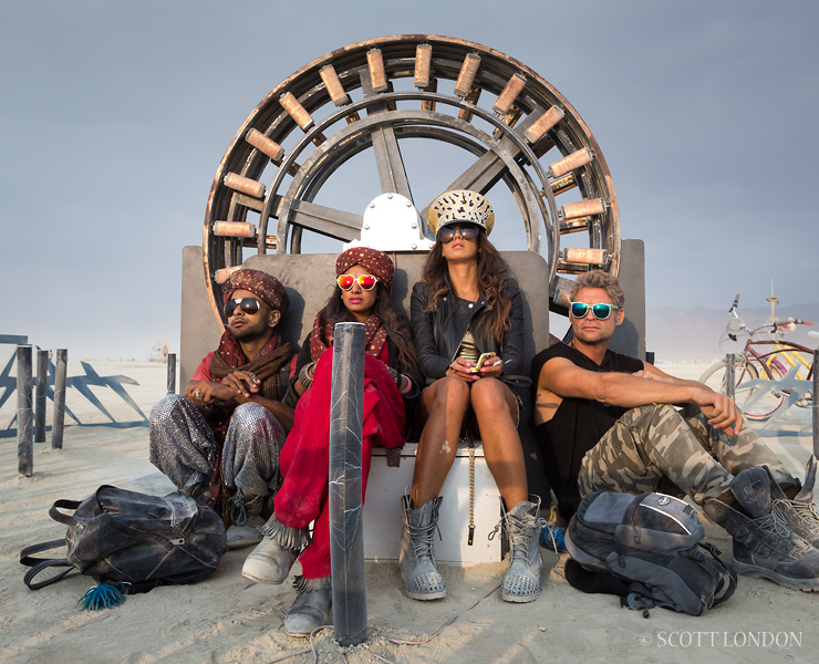 Tired Burners take in the sunrise at Sparky's Wheel of Tesla, an installation by Kat and Jesse Green at Burning Man 2013 (Photo by Scott London)