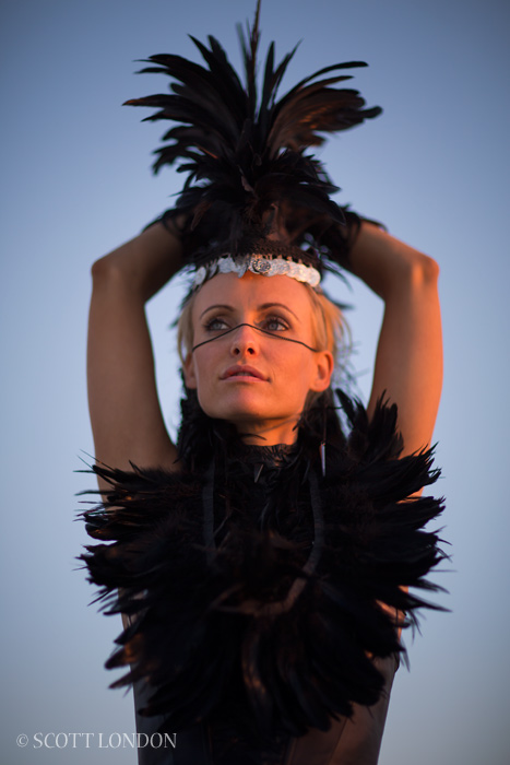 Lia in a feather outfit and headpiece at Burning Man 2013 (Photo by Scott London)