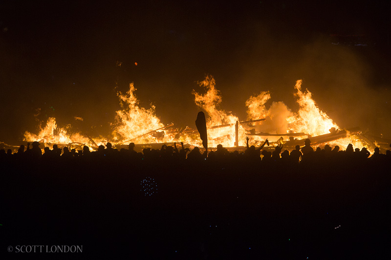 The crowd erupts after the man goes up in flames at Burning Man 2013 (Photo by Scott London)