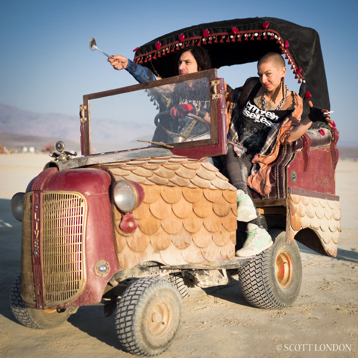 This hobbled vehicle, part of Mr. Toad's Gypsy Wagon, was stranded out on the playa without a rear wheel. It turned into another interactive art piece, with people doing spontaneous performance art and outlandish photo shoots. (Photo by Scott London)