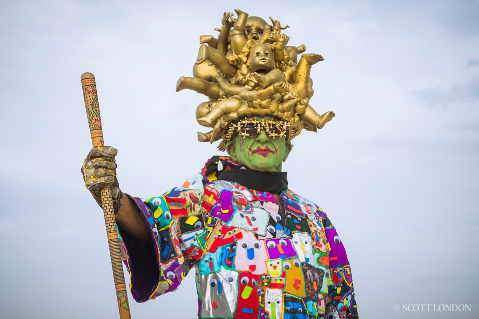 Uncle Ira, a costume designer from San Jose, fashioned a colorful smock and gold headpiece made of baby doll parts. (Photo by Scott London)
