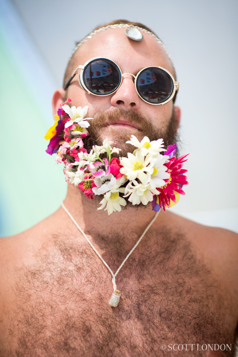 First-time Burner Justin wore flowers in his beard and a sprinkling of playa dust around his neck. (Photo by Scott London)