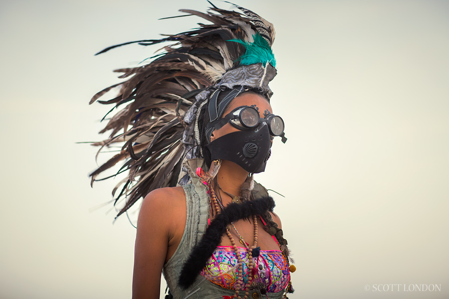 Rizia, a first-time burner from Brazil, wearing goggles and a dust mask in a wind storm at Burning Man 2015. (Photo by Scott London)