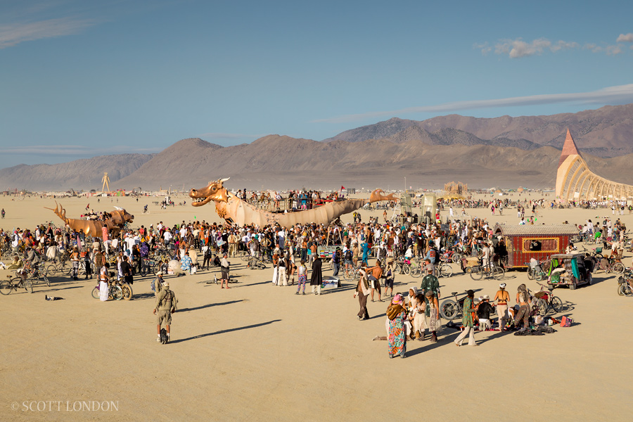 Crowds gather for a morning dance party at the art car Abraxas at Burning Man 2015. (Photo by Scott London)