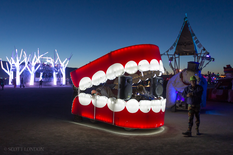 The Chatter Box, Forest House and other art cars roam the playa after dark at Burning Man 2015. (Photo by Scott London)