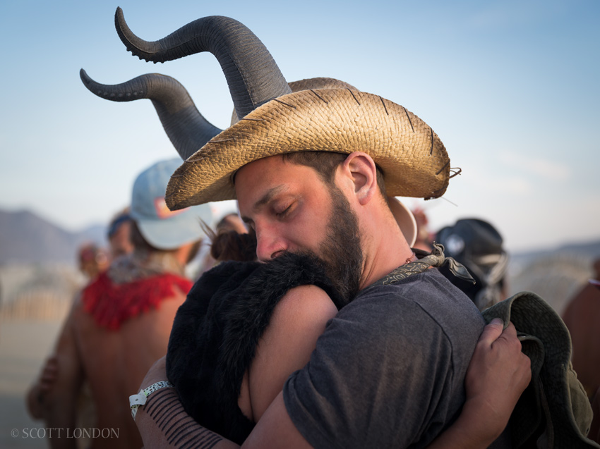 A heartfelt embrace following the opening ceremony of the Temple of Promise at Burning Man 2015. (Photo by Scott London)