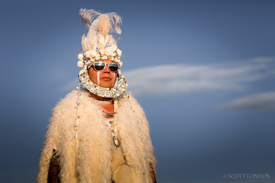 David, a San Francisco–based stylist and designer, wore white fur and an ornate headpiece made of beads, feathers and pom poms at Burning Man 2015. (Photo by Scott London)