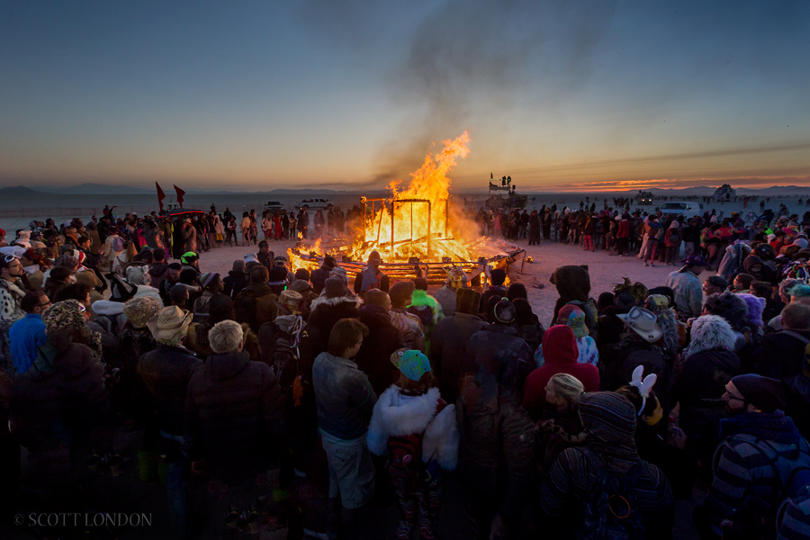 The art installation 'Reflection' is set on fire on a pre-dawn ceremony at Burning Man 2015. (Photo by Scott London)