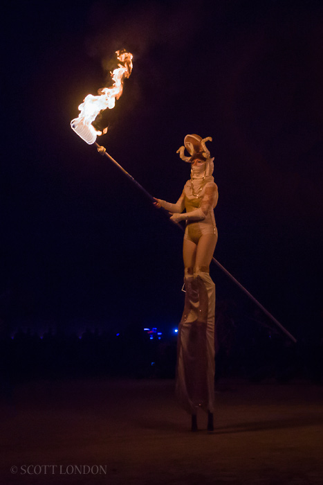 One of the participants of the Fire Conclave procession carrying a flaming spear at Burning Man 2015. (Photo by Scott London)