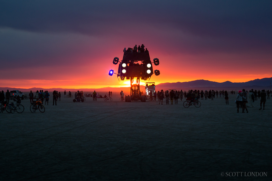 People take in the sunrise atop the Icarus art car at Burning Man 2016