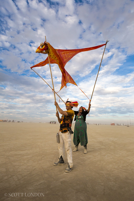 Gus and Rita fly 'Phoenix,' a kite by artist Toni Tone at Burning Man 2016. (Photo by Scott London)