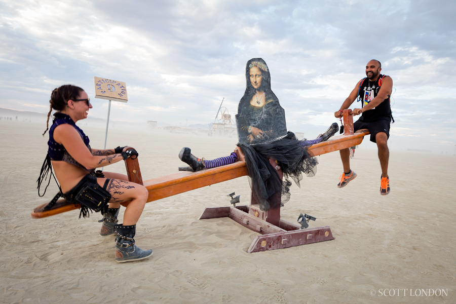 A couple on a Mona Lisa teeter-totter at Burning Man 2016. (Photo by Scott London)