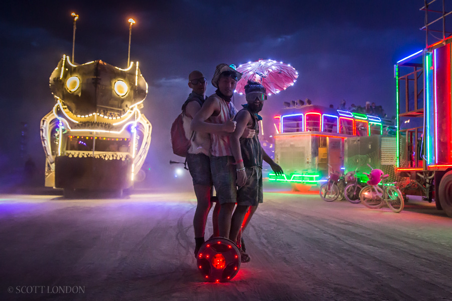 Three guys on a Segway at Burning Man 2016. (Photo by Scott London)