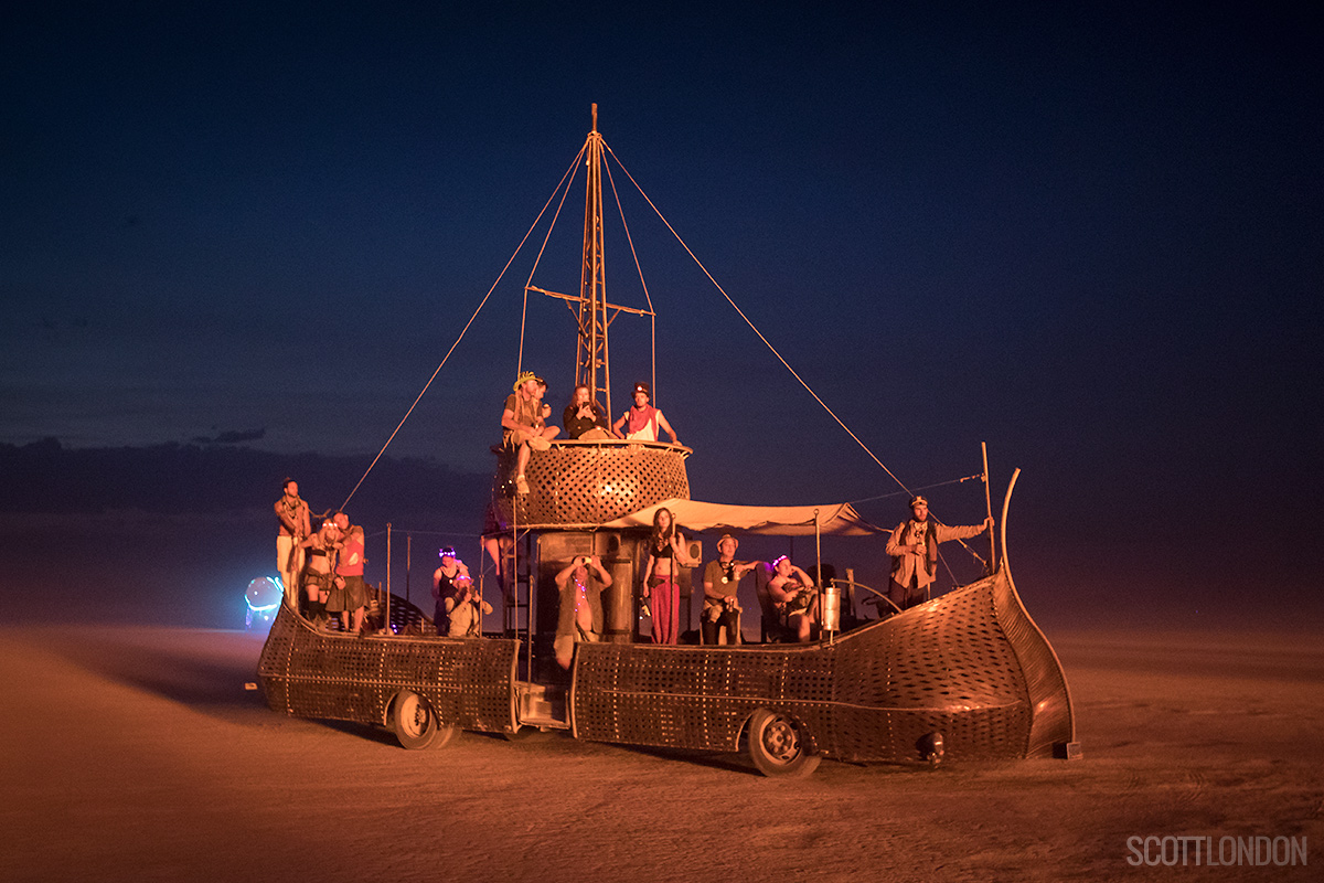 People watch the temple burn from Fjorgyn, an art car at Burning Man 2017. (Photo by Scott London)