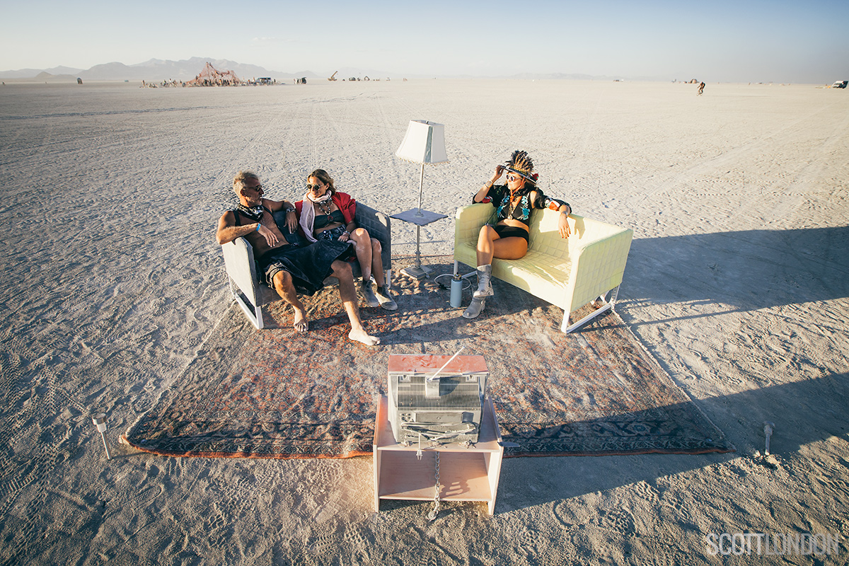Three burners relax at an art installation at Burning Man 2017. (Photo by Scott London)