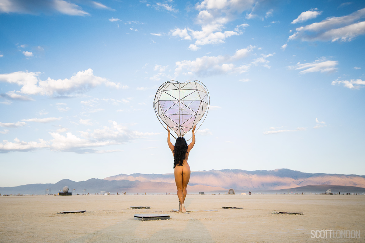 A nude and and an art installation in the form of a heart at Burning Man 2017. (Photo by Scott London)
