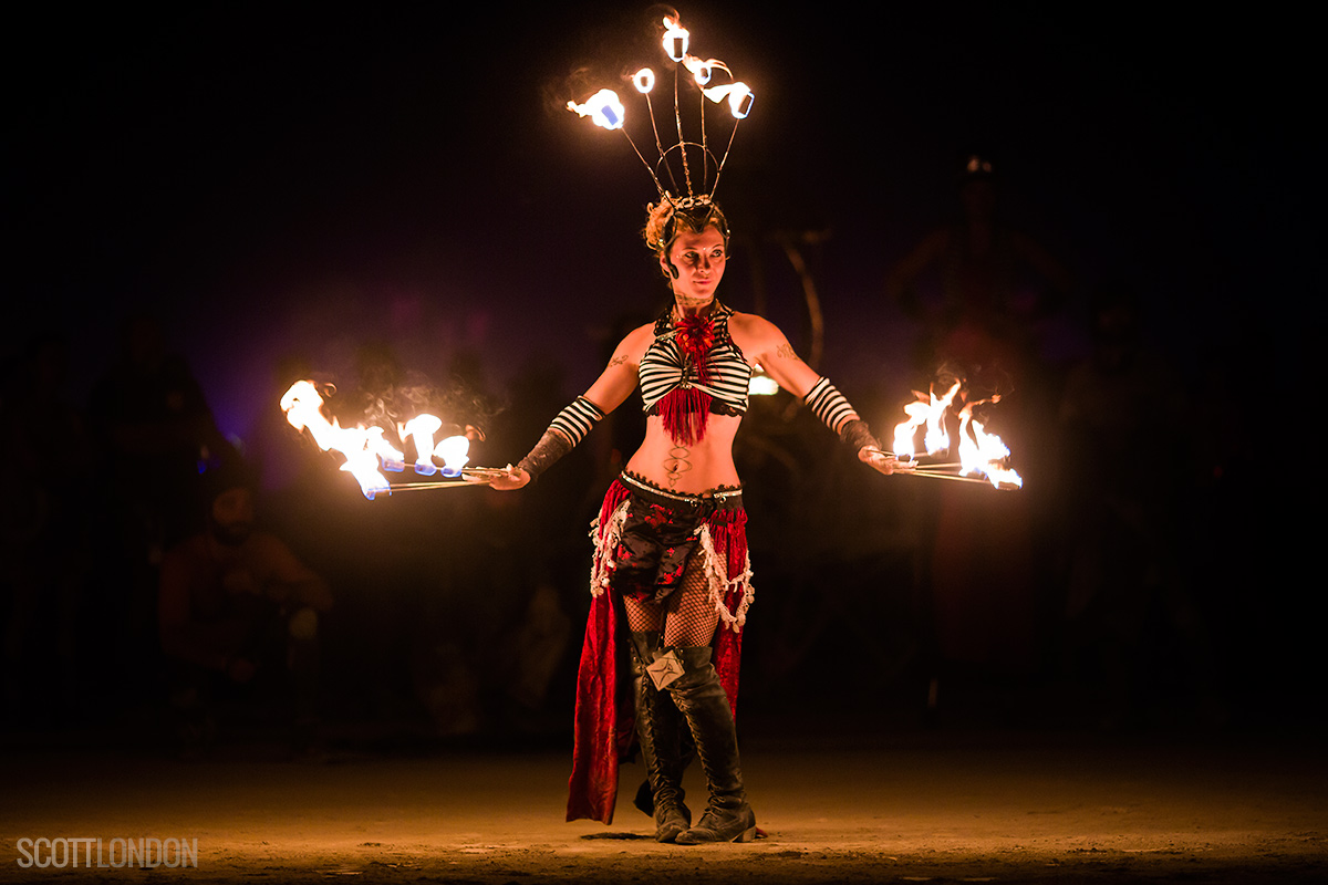 A beautiful fire performer with the troupe Fractal Tribe puts on a show as part of the Fire Conclave at Burning Man 2017. (Photo by Scott London)