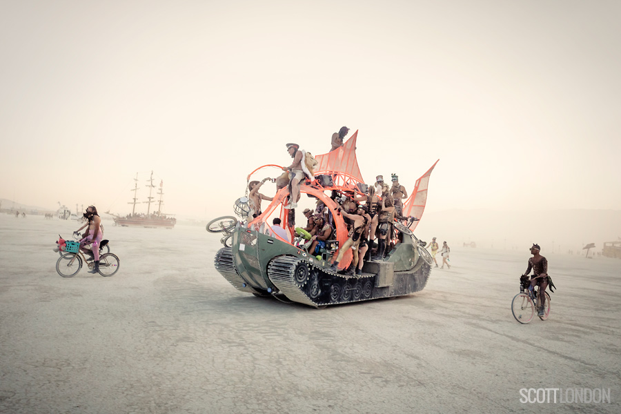 Burning Man participants on bikes and mutant vehicles, riding through the dust. (Photo by Scott London)