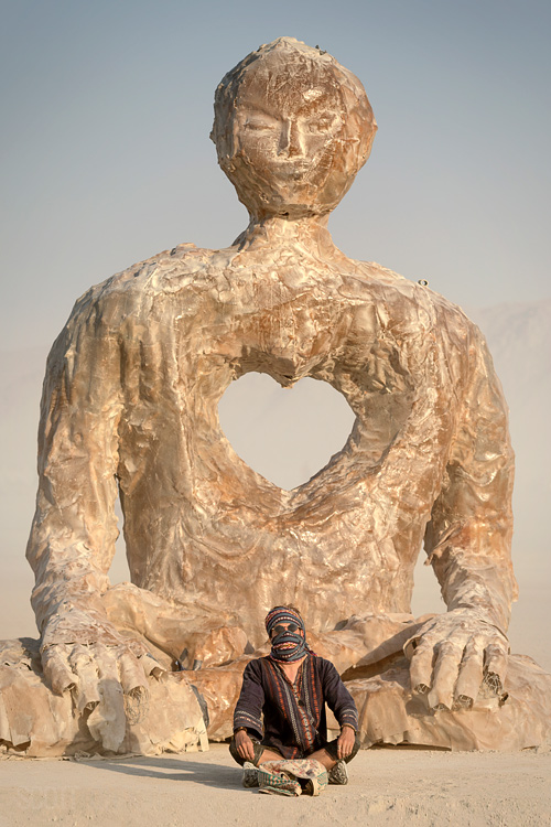 A Burner meditates at 'The Open-Hearted Meditator (OHM),' an installation by Swig Miller, at Burning Man 2018. (Photo by Scott London)