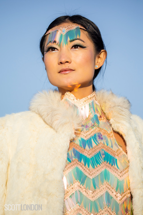 Angela Zhao wearing an iridescent sequin dress and fur at Burning Man 2018. (Photo by Scott London)