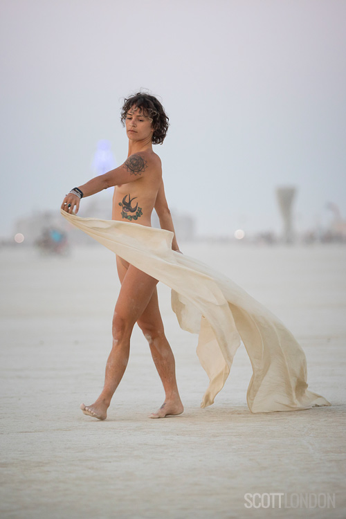 A woman dances with a silk at Burning Man 2018. (Photo by Scott London)