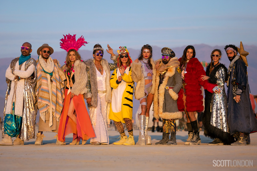 Colorful and beautifully dressed Burners line up for a group photo at Burning Man 2018. (Photo by Scott London)