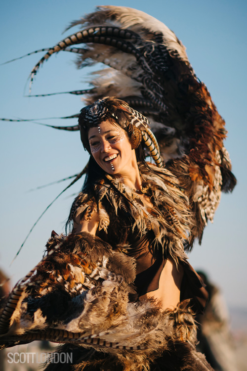 Ildiko performs a sunrise dance at Burning Man 2018 in a full-body feather embodiment. (Photo by Scott London)