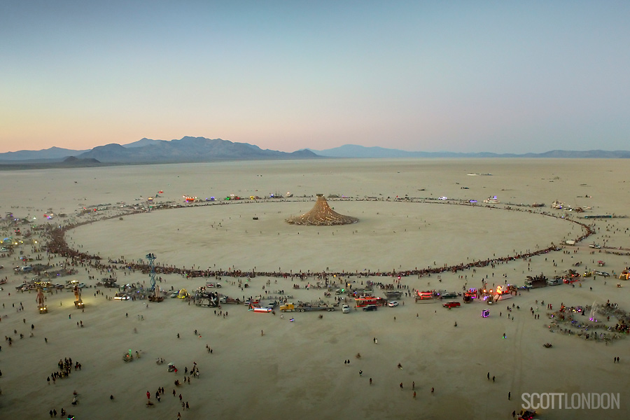 Thousands gather in a great circle to watch the Galaxia temple burn on the penultimate night of Burning Man 2018. (Photo by Scott London)