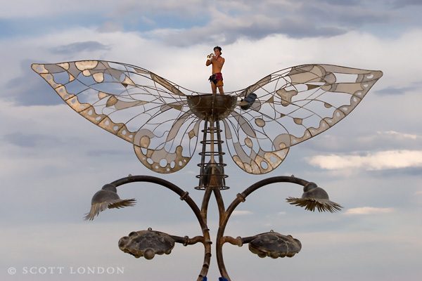A Trumpeter Issues a Fanfare from Atop 'The Portal of Evolution'
