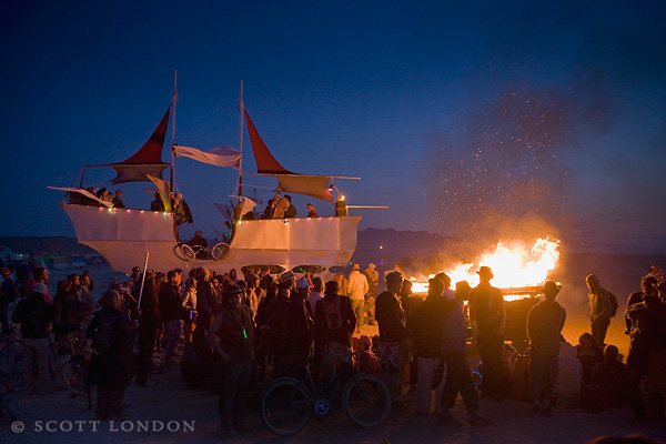 Crowds Gather Around the Pirate Ship at Daybreak