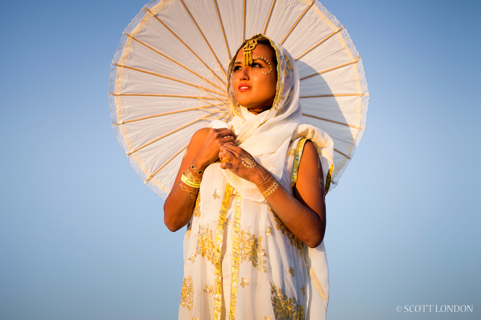 Christie, a Burner from New York, takes in the sunrise at the Temple of Grace. (Photo by Scott London)