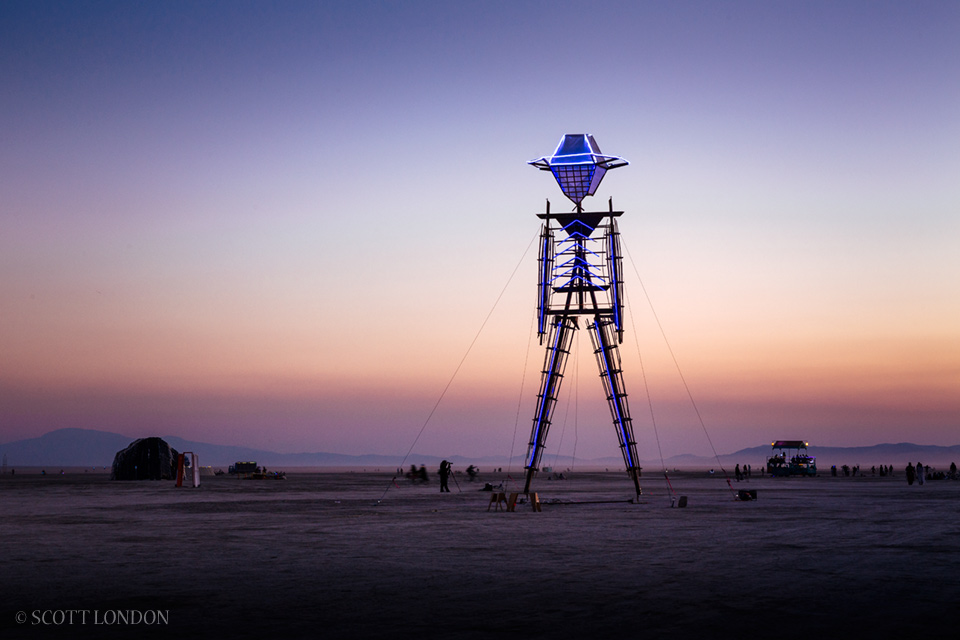 Genesis Man, an alternate 'man' donning a neon Stetson (like Burning Man co-founder Larry Harvey), hearkened back to the early days of the event when the effigy was cobbled together from wood and neon and raised up by the participants themselves. (Photo by Scott London)