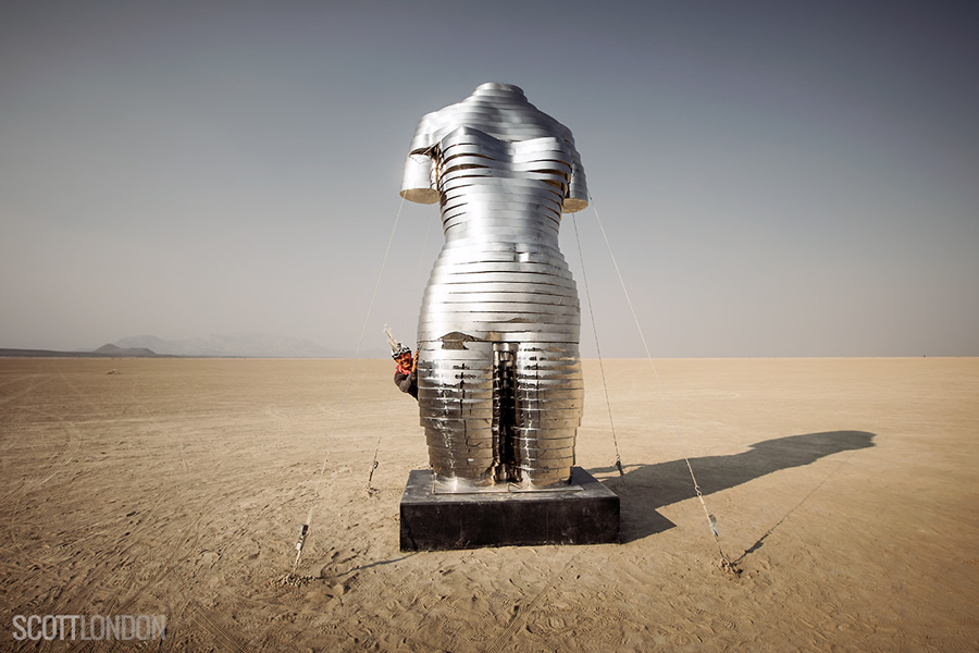 Kai peers out from behind 'Mirage,' an art installation by Michael Benisty at Burning Man 2017. (Photo by Scott London)