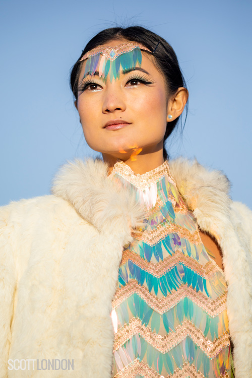 Angela Zhao wearing an iridescent sequin dress and fur at Burning Man 2018. (Photo by Scott London)